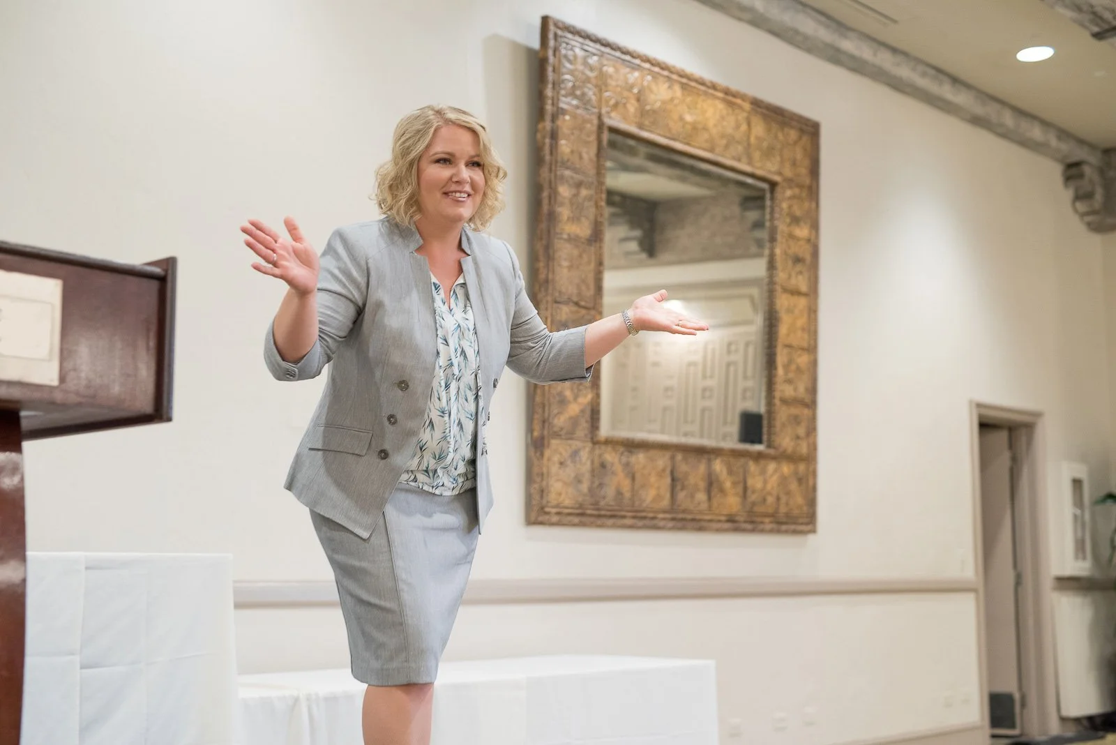 Female public speaker presenting on stage