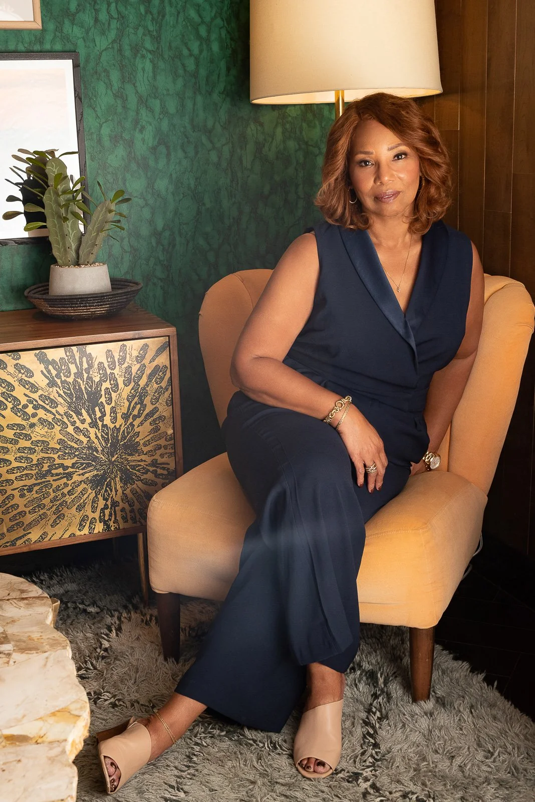 Executive woman seated in modern interior setting for editorial brand portrait session in Southern California.