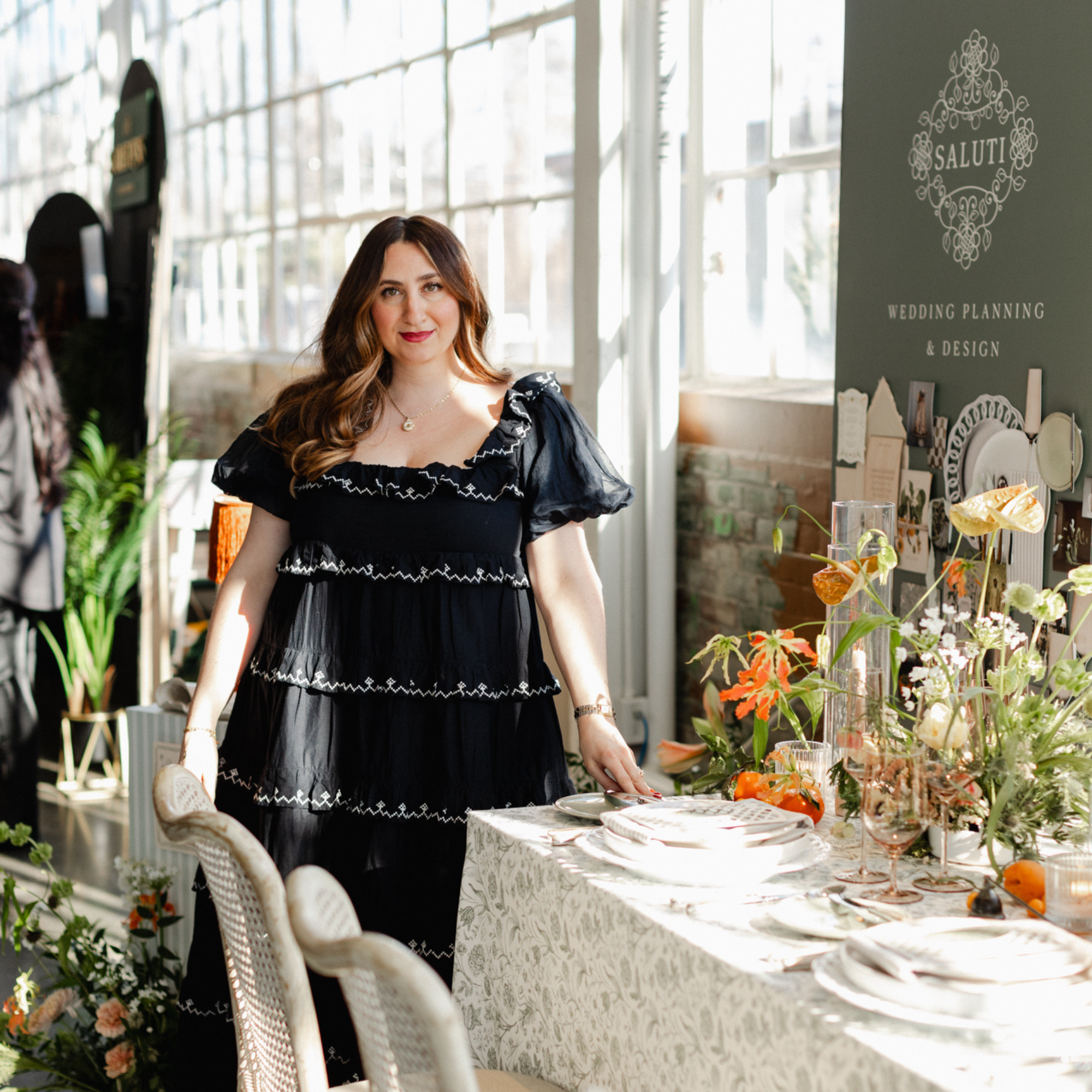 wedding planner Dana Saluti standing in her booth at Wed Well Showcase