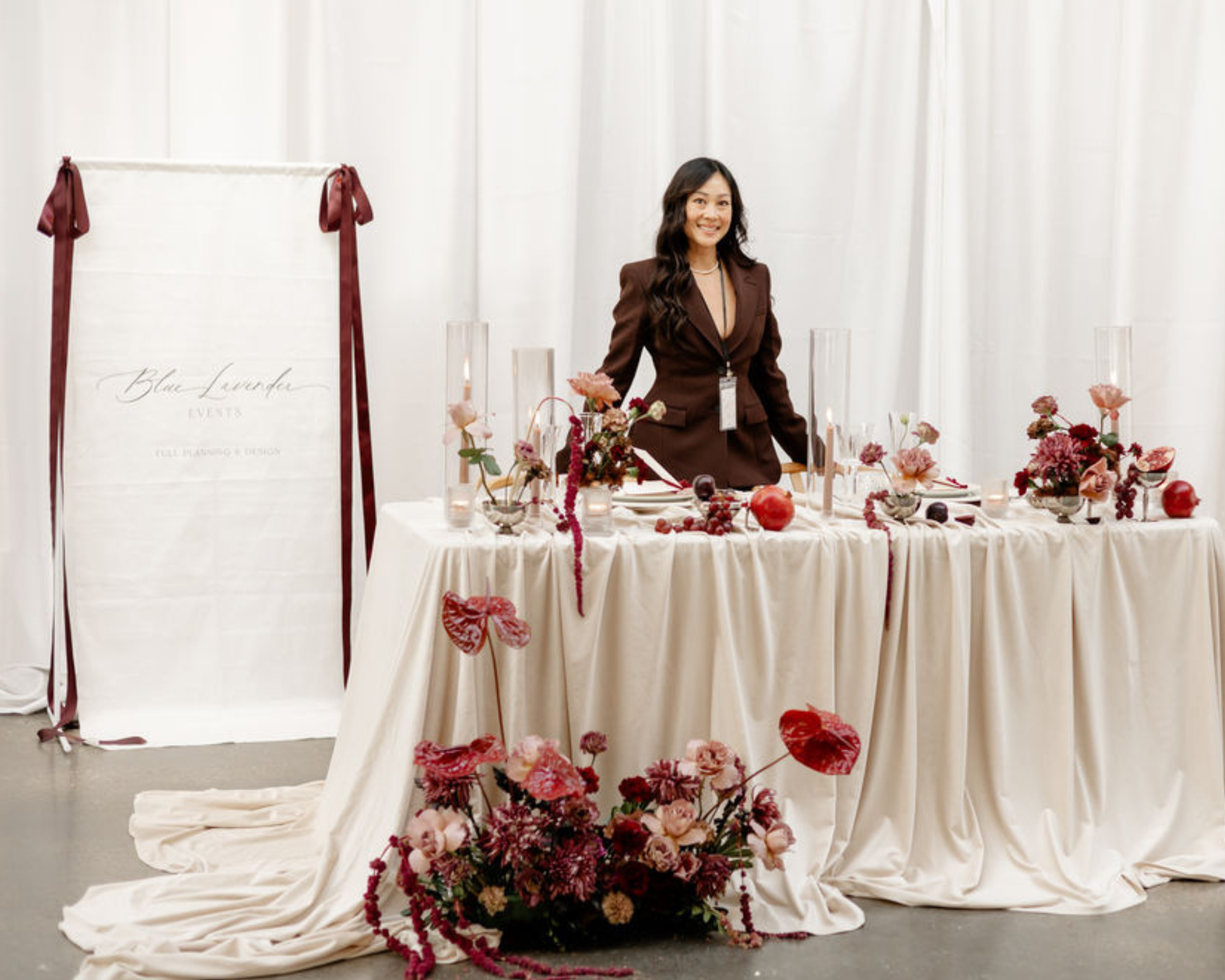 wedding planner Blue Lavender Events standing in her booth at Wed Well Showcase