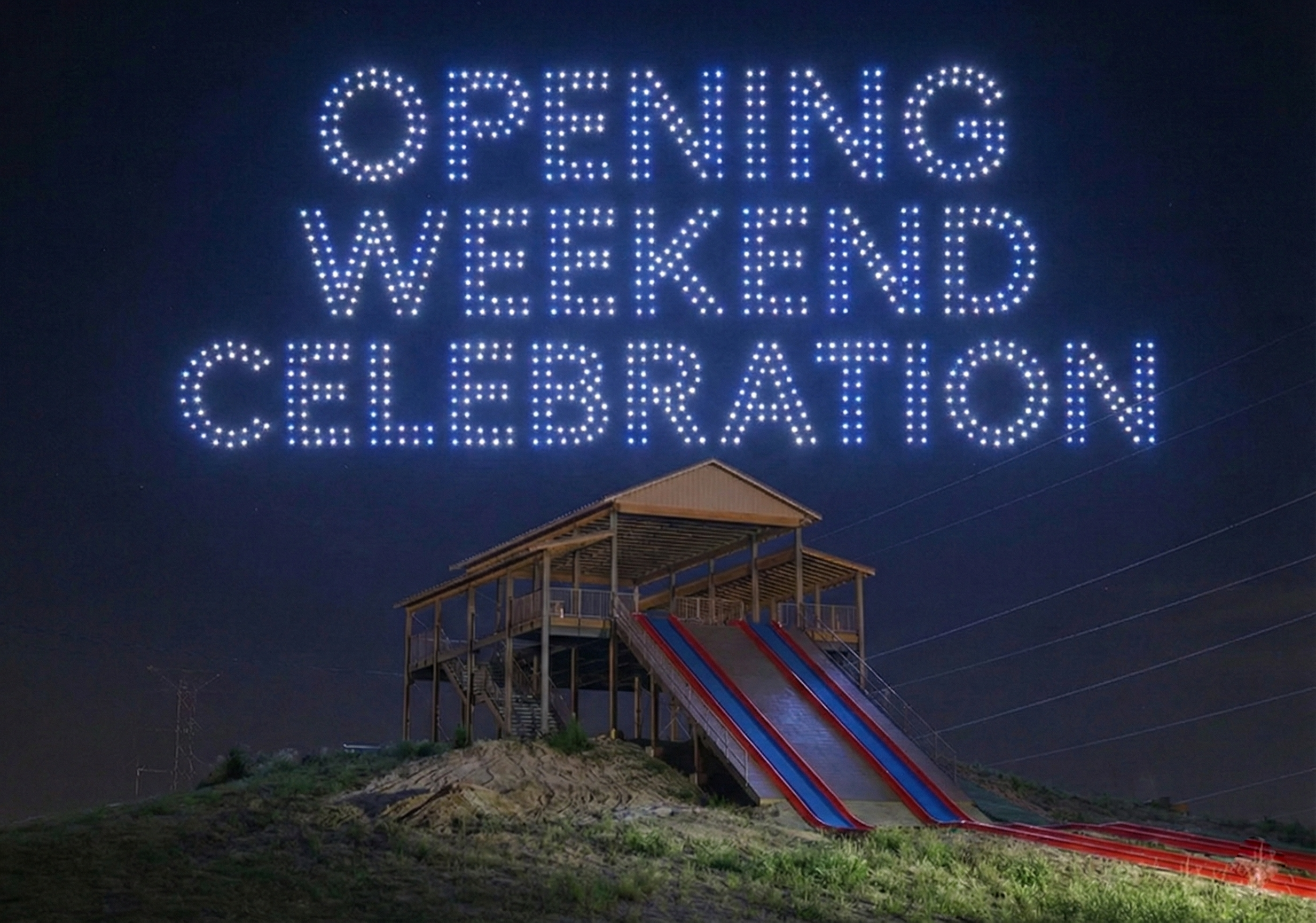 Young boy running on a yellow and green obstacle in a life vest in a lake.