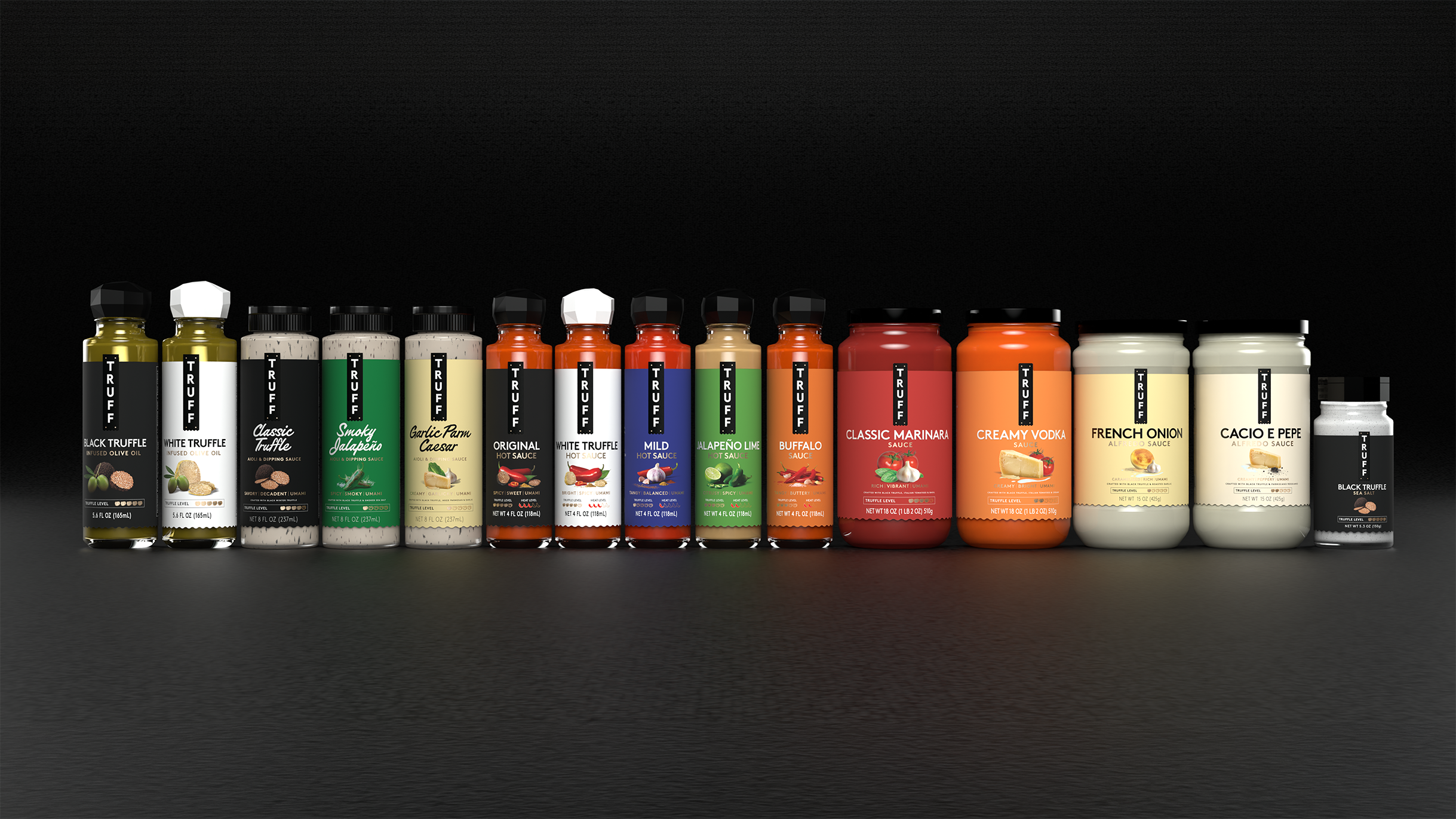 Lineup of various Truff hot sauces and sauces in bottles and jars, including black truffle, white truffle, classic truffle, smoky jalapeño, garlic parmesan Caesar, original hot sauce, mild hot sauce, jalapeño lime, buffalo sauce, classic marinara, creamy vodka, French onion, cacio e pepe, and sea salt flavors.