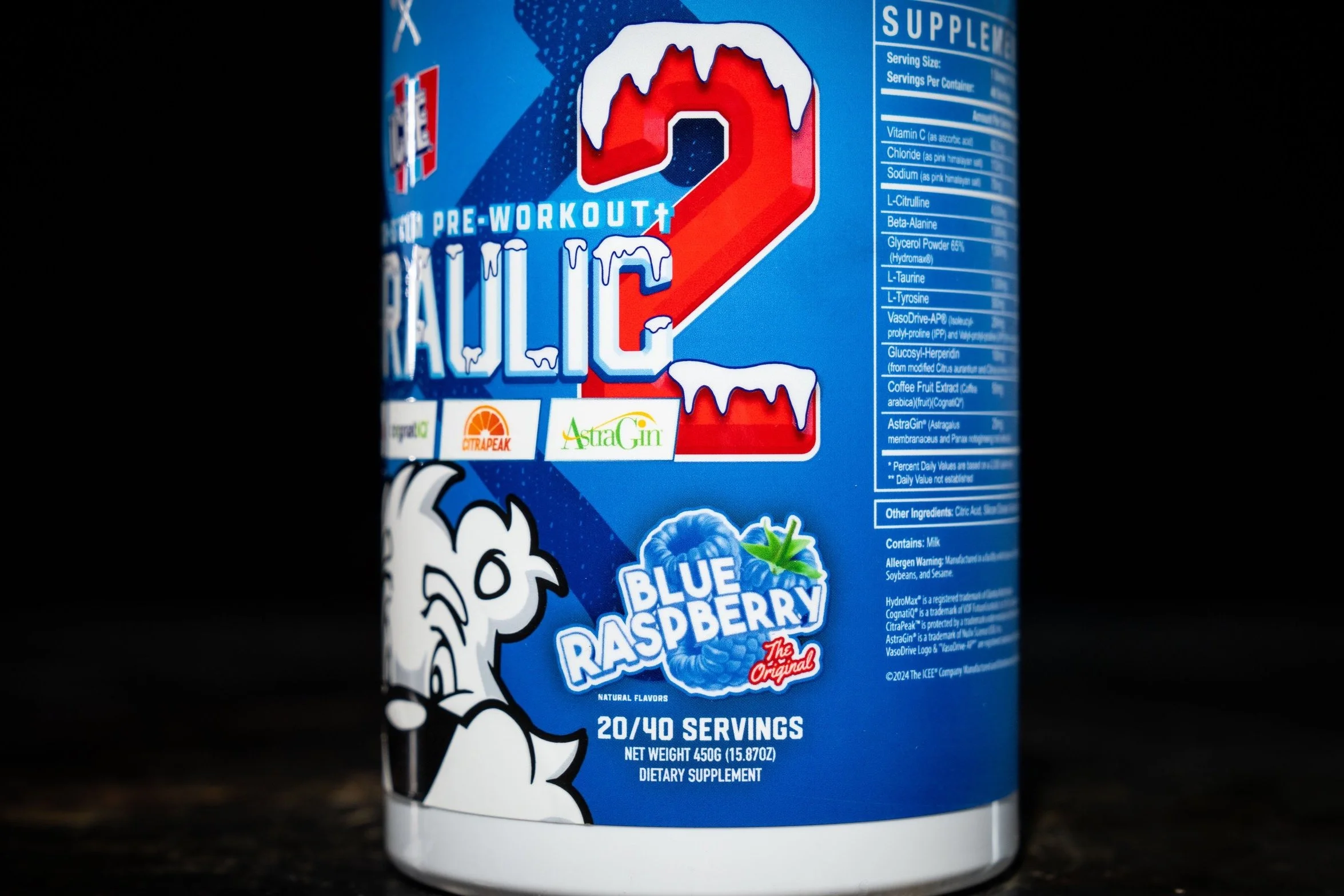 Container of Blue Raspberry flavored electrolyte powder, labeled as a dietary supplement with 20 out of 40 servings, weighing 450 grams, featuring a cartoon illustration of a chicken, and branding logos including CitraPeak and AstraGin.