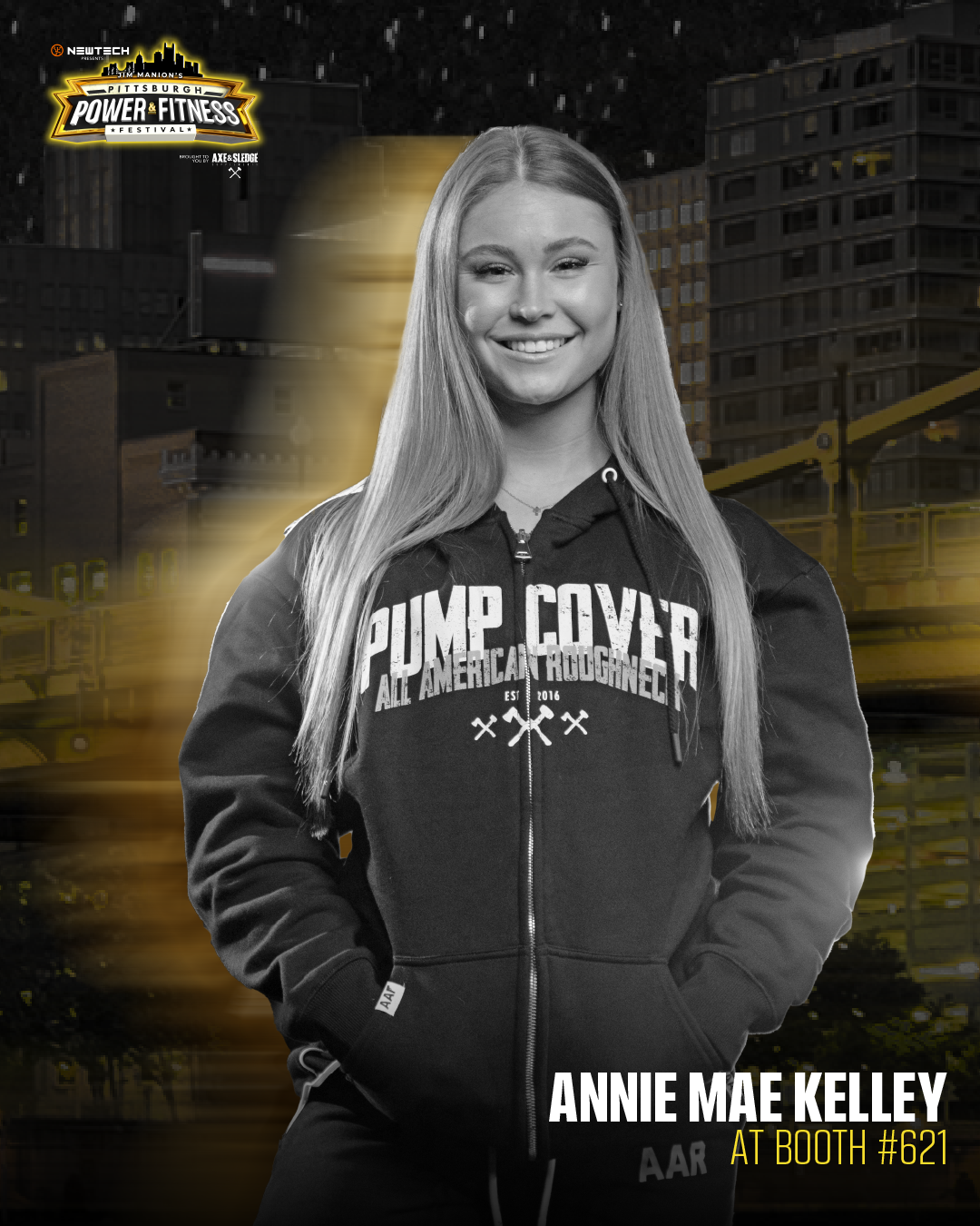 Black and white photo of a young woman with long hair smiling, wearing a hoodie that says 'PUMP COVERER' and 'ALL AMERICA ROUGNED' with small graphics underneath. The background features a cityscape at night with yellow lighting effects and a logo in the top left corner that reads 'PITTSBURGH POWER & FITNESS FESTIVAL'. Text at the bottom right indicates her name, Annie Mae Kelley, and her booth number, #621.