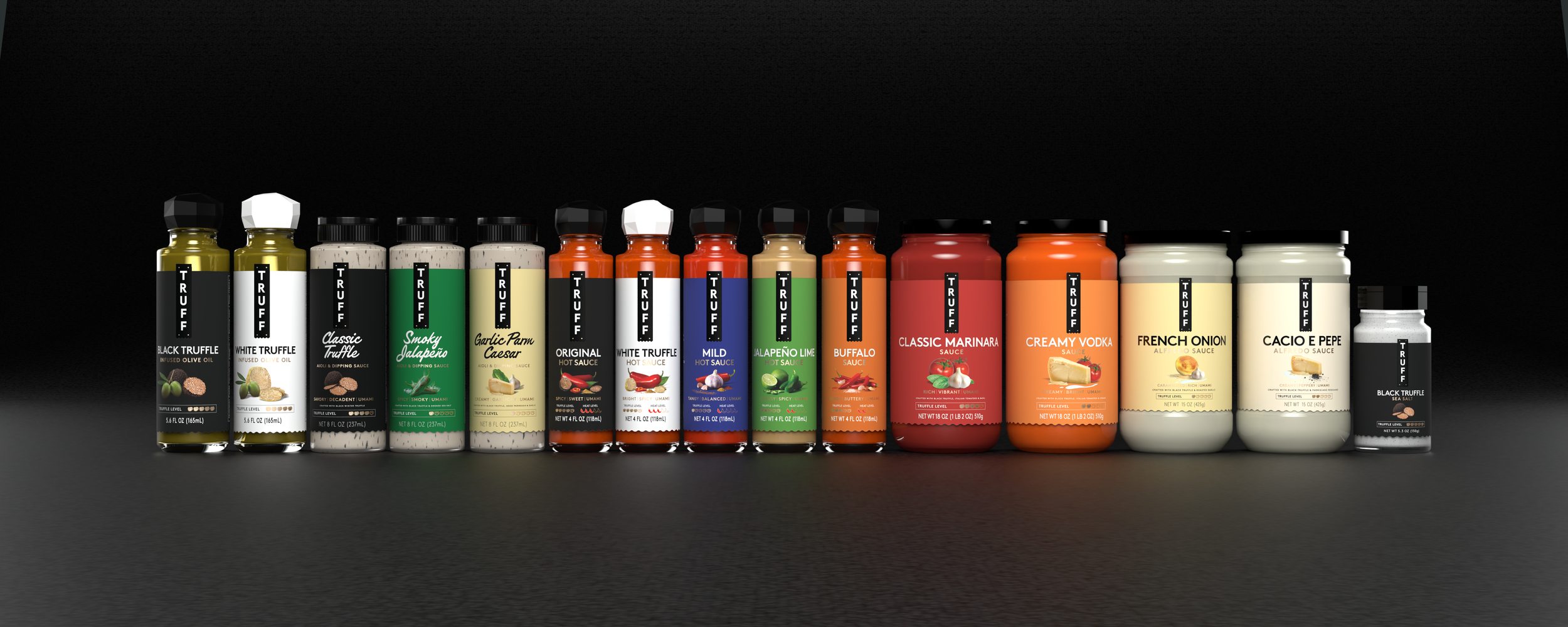 A row of various flavored TRUFF hot sauces and seasonings in bottles with black caps, arranged on a dark surface against a black background.