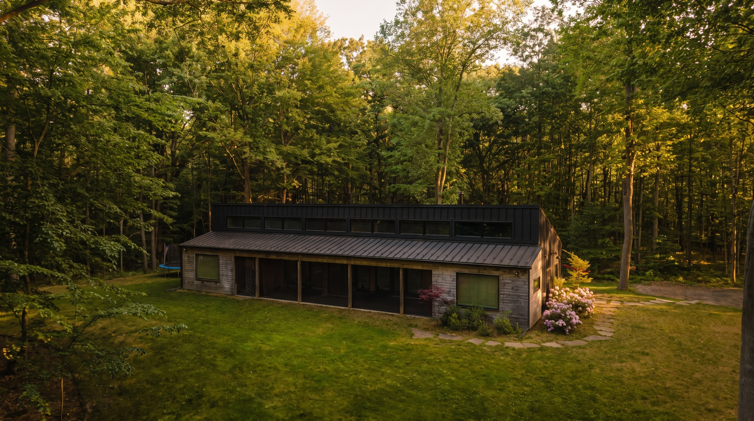 Lake Effect Cabin at dusk on its 3.5-acre wooded lot near Holland and Saugatuck