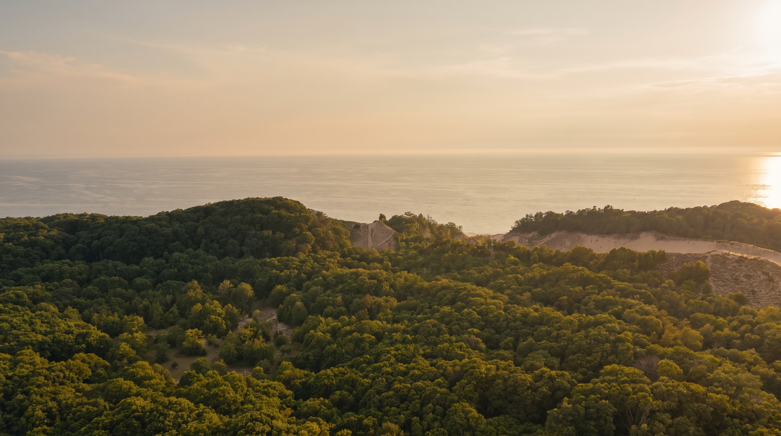 Aerial view of wooded Lake Michigan dunes at sunset near Saugatuck, close to Lake Effect Cabin
