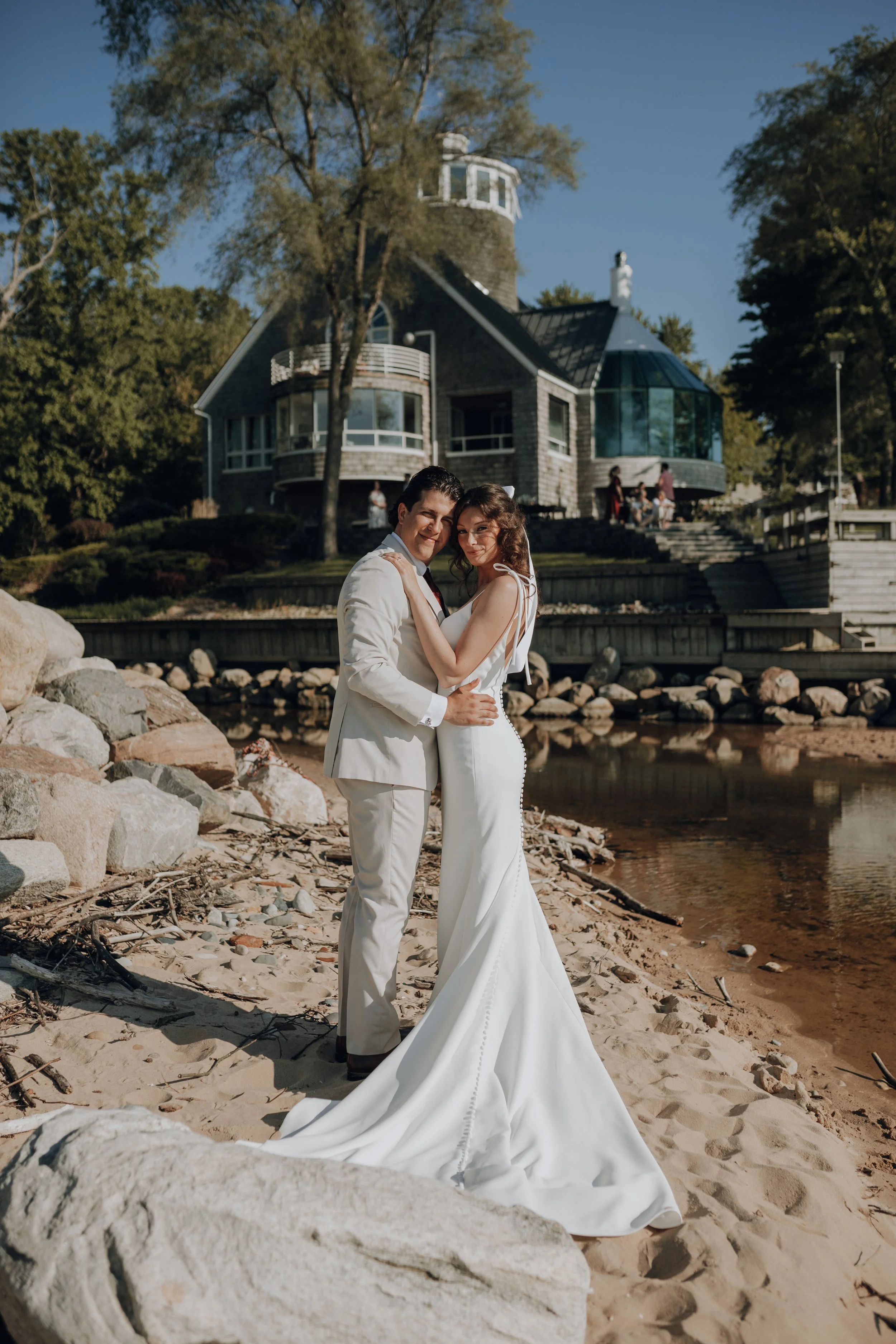 Wedding couple on the private beach in front of Lighthouse Bluff on Lake Michigan