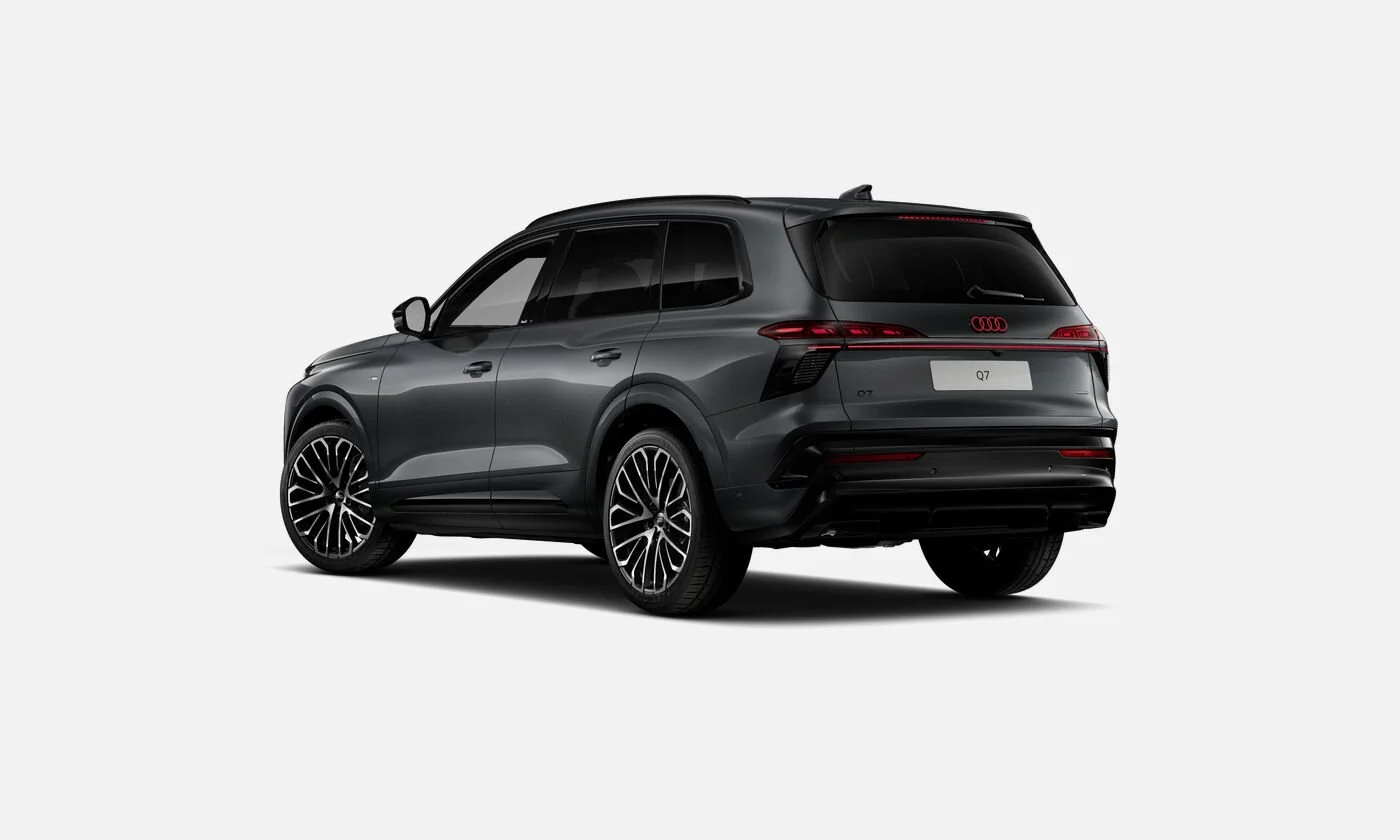 A black Audi Q7 SUV viewed from the rear on a plain white background.