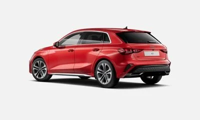 Red hatchback car viewed from the rear left side against a plain background.