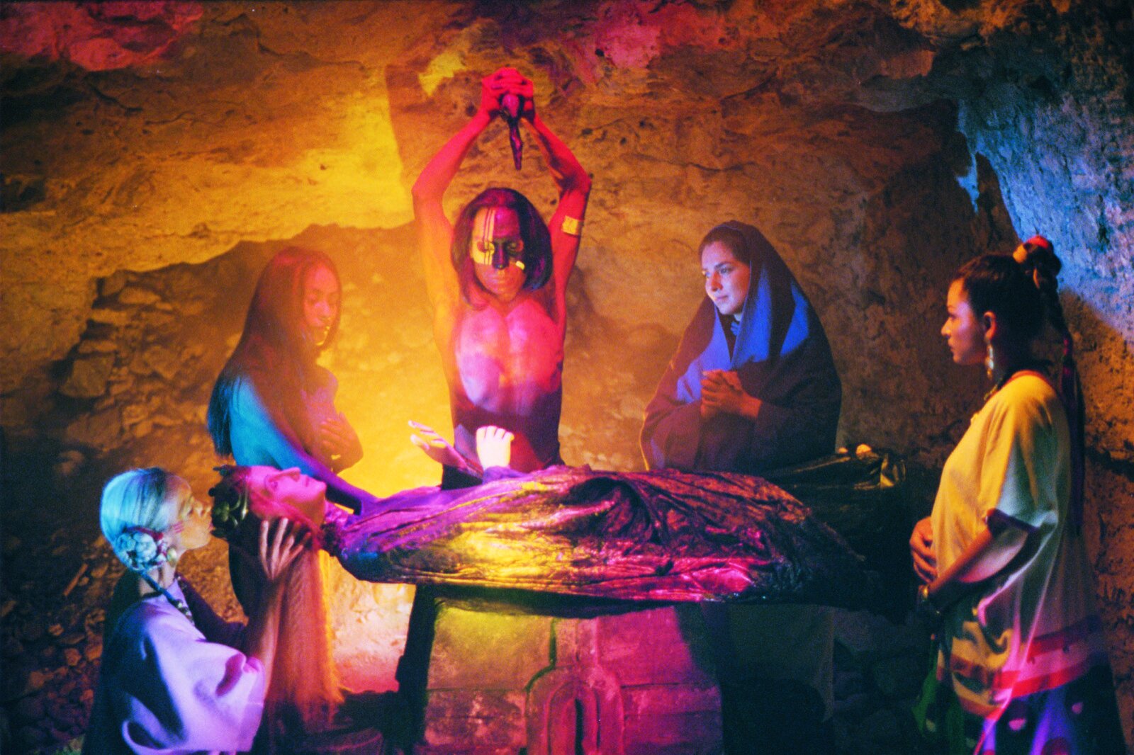   Topiltzin has a hallucination in which he sees himself as an Aztec high-priest about to sacrifice the statue of the Virgin Mary. He is surrounded by the women whom he loses throughout the film: from left to right, his grandmother Nanahuatzin, the p