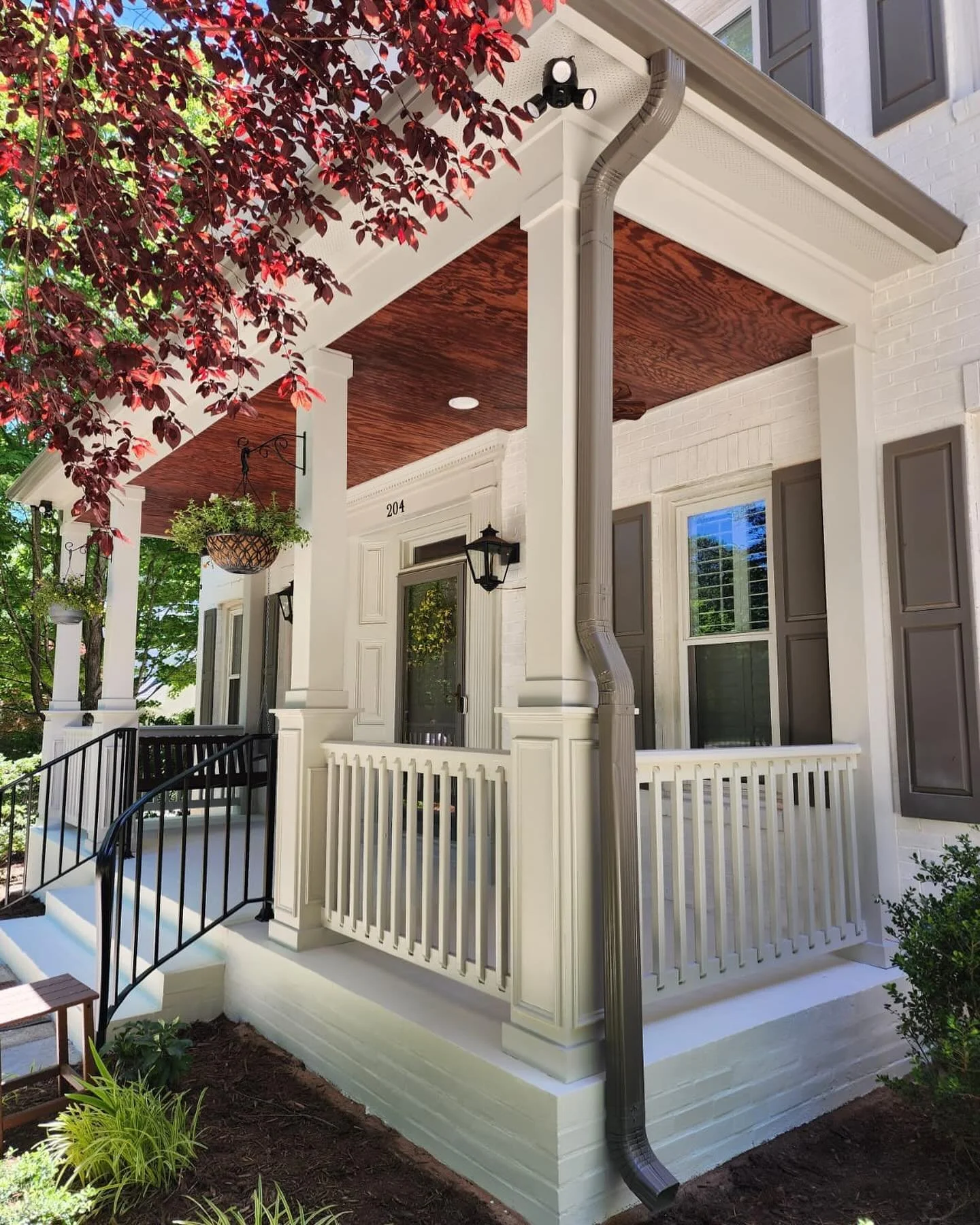 We are loving the refresh of this newly constructed front patio. 

-painted all new trim, stair rails, spindles and posts
-painted new gutters
-stained ceiling 
-stained brick stairs and landing