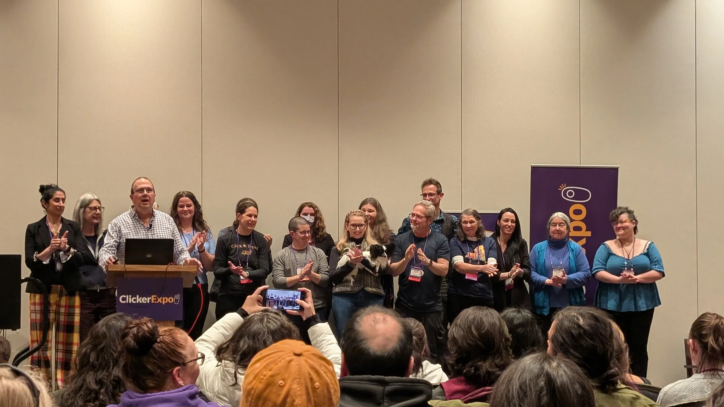 All of the Clicker Expo speakers, on stage, giving a round of applause during the closing talk