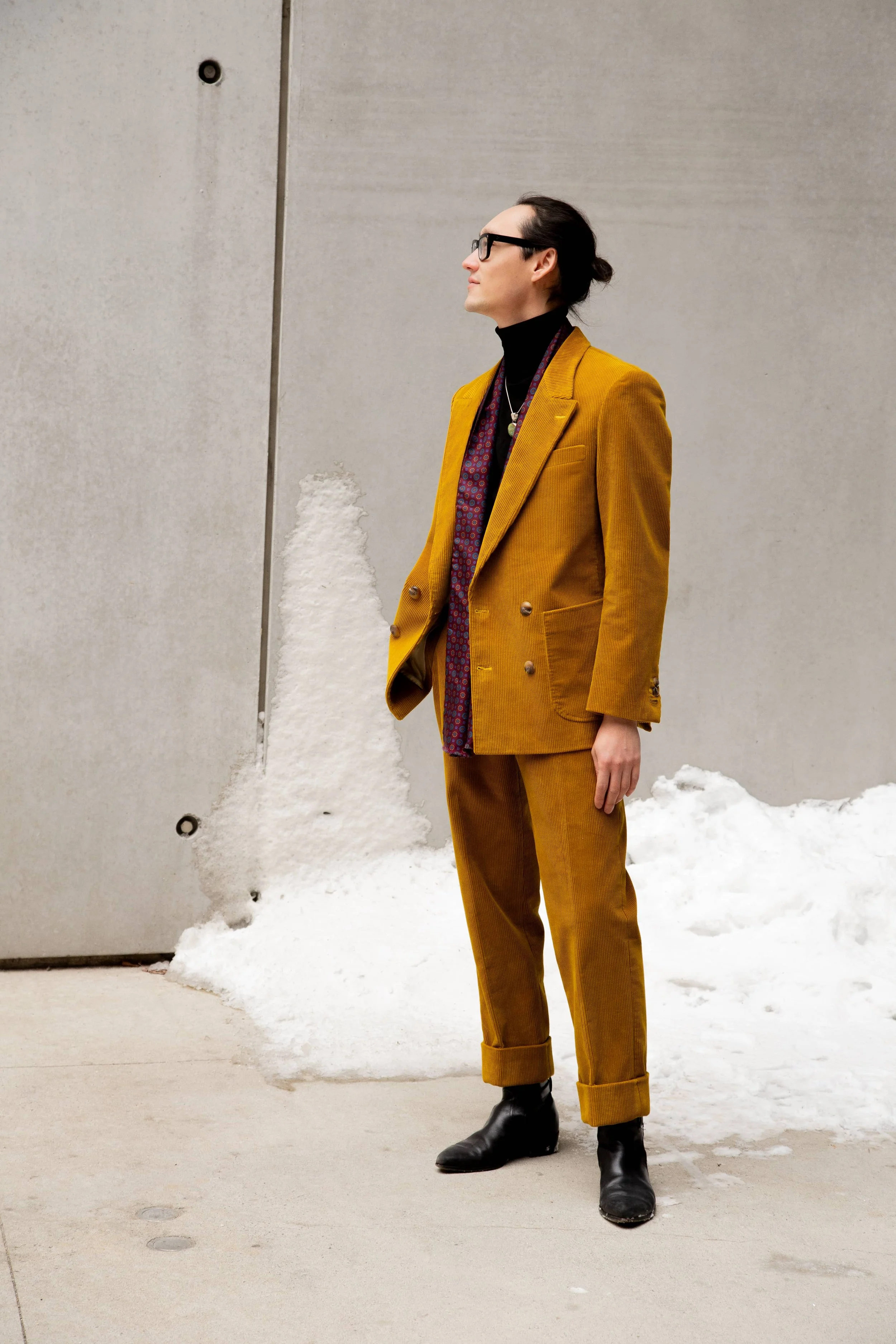 man in a mustard yellow double breasted corduroy suit