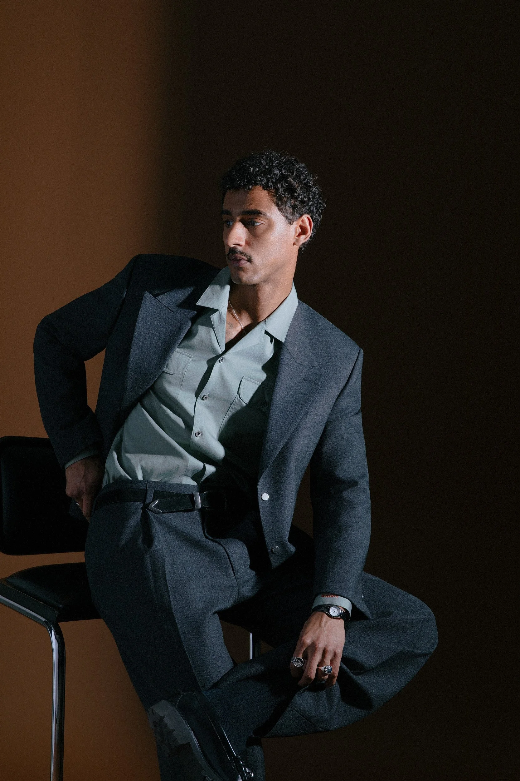 In a charcoal Fox Air Cloth we embrace modern menswear here with the perfectly cropped and boxy jacket (not too cropped) with wide exaggerated shoulders and a horizontal peak lapel, topped off with our custom snaps for closure. This must be paired wi