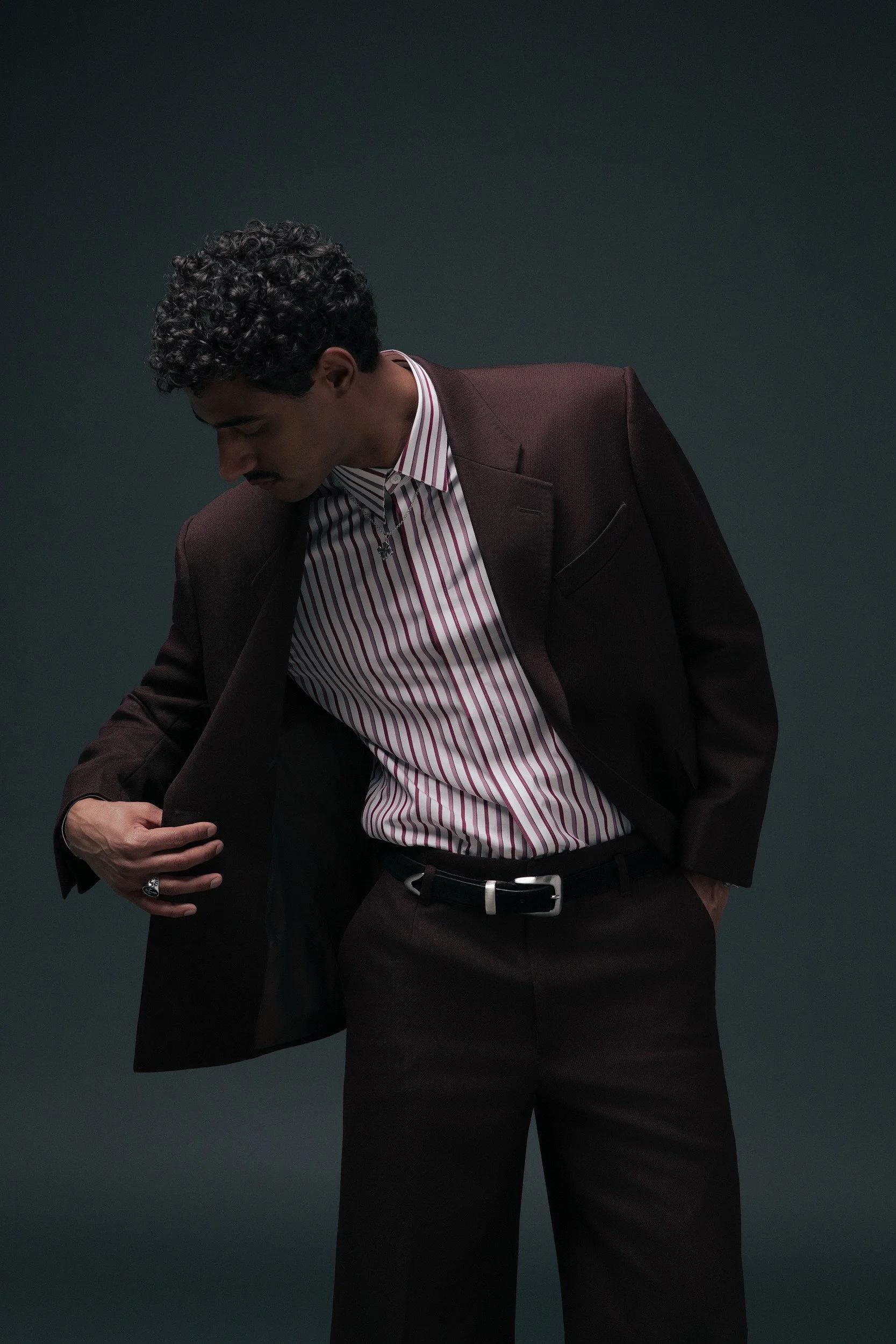 Our oxblood Twill jacket. A deep burgundy two-piece double breasted jacket with wide notch lapels. Pants have a Hollywood waistband with wide legs. Worn here with a pink and burgundy candy-stripe shirt and western belt — equally at home at a dinner, 