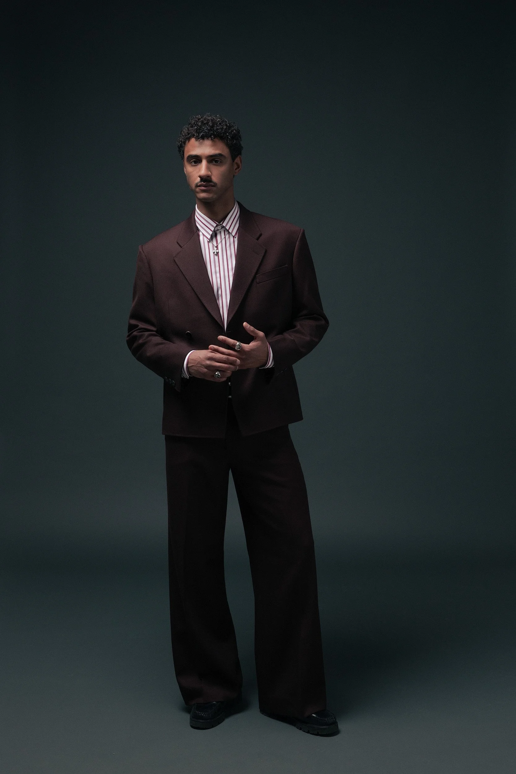 Men's burgundy double breasted suit with a cropped jacket and wide leg trousers, paired with our pink and white wide stripe custom shirt