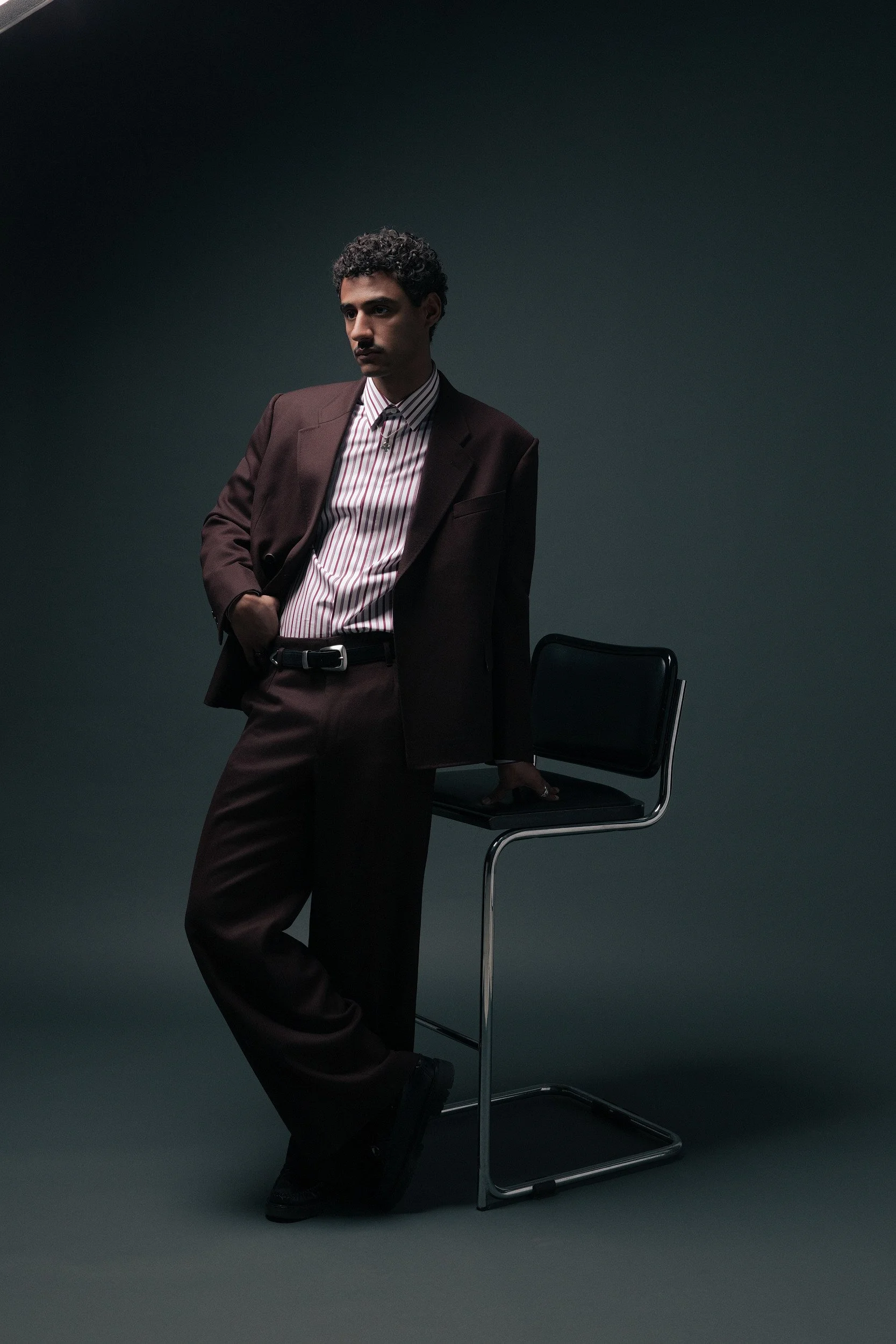 Our oxblood Twill suit. A deep burgundy two-piece double breasted jacket with wide notch lapels. Pants have a Hollywood waistband with wide legs. Worn here with a pink and burgundy candy-stripe shirt and western belt — equally at home at a dinner, a 