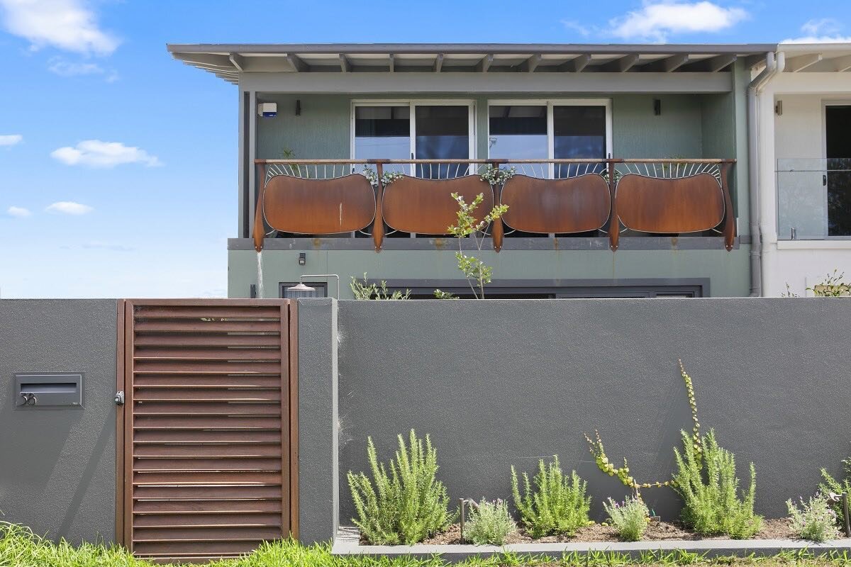 || Hickson || A front facade can change the whole dynamic of a house. The custom timber hard wood gates tie in with the unique metal balustrade. #architecture #construction #builder