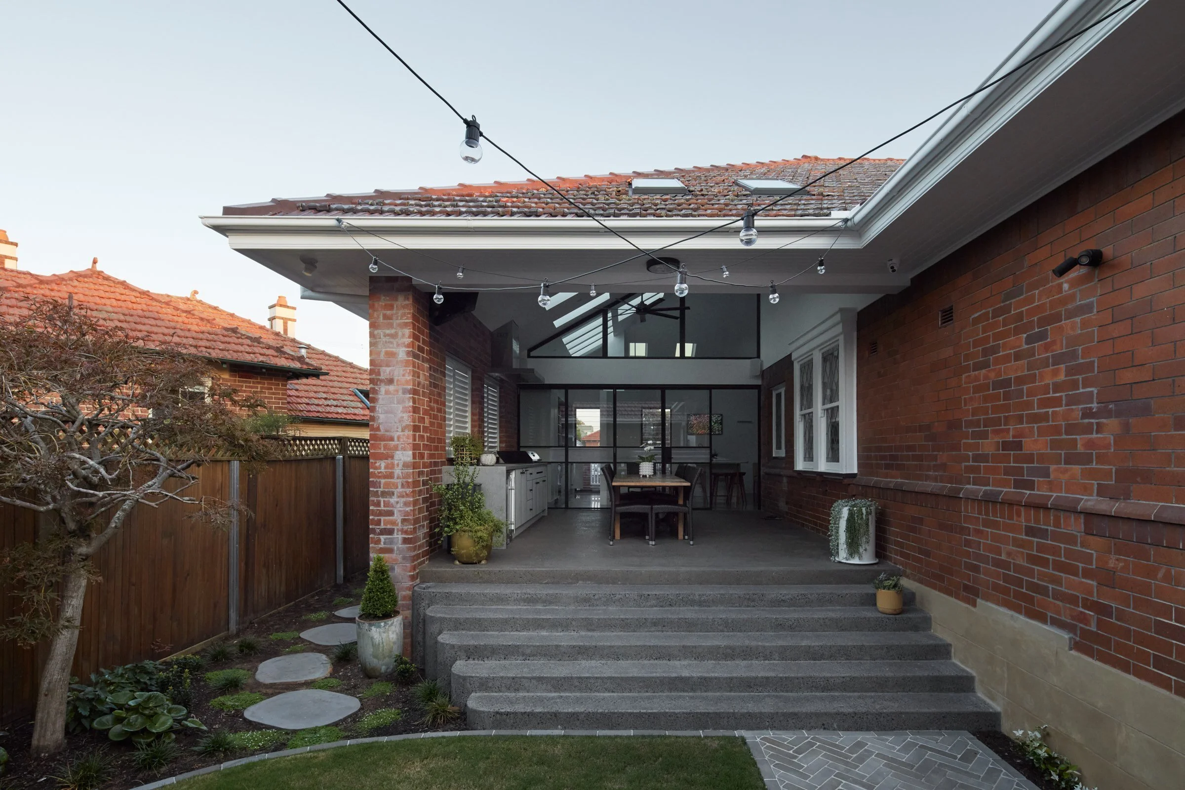 New skillion roof meeting original brick, Hamilton Heritage renovation