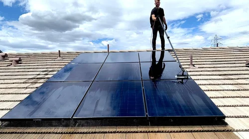 Top Line Solar cleaning panels on a Sacramento roof
