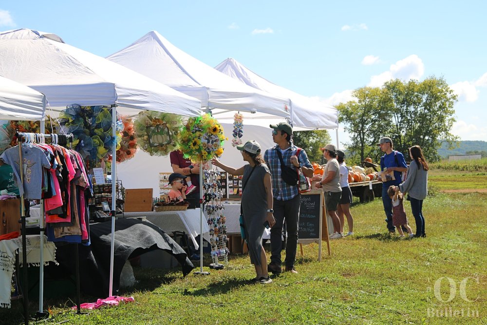  Attendees at the Liberty Mills Fall Farm Festival shop the vendor tents on Oct. 1. (Photo Credit: Andra Landi) 