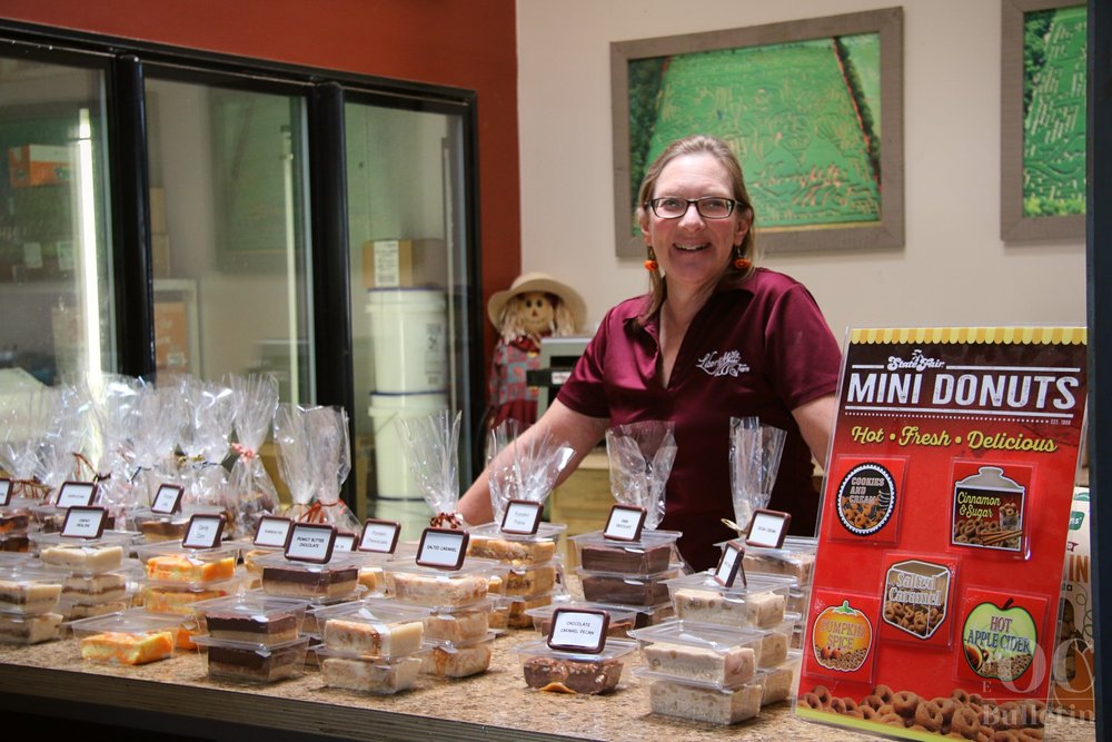  Liberty Mills co-owner Evie Woods manages the fudge station during the Fall Farm Festival. (Photo Credit: Andra Landi) 