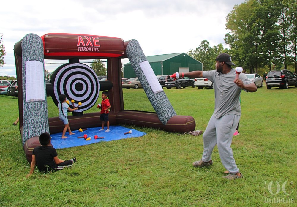  Shaun Long readies himself for a perfect inflatable axe throw during Community Give Back Day on Saturday. (Photo Credit: Andra Landi) 