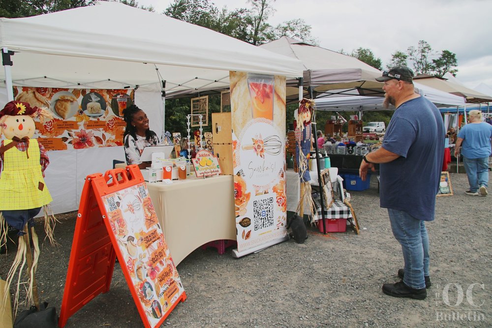  Ketra Dixon of Snicka’s Cookies chats with a customer at Deep Roots Fall Festival. (Photo Credit: Andra Landi) 