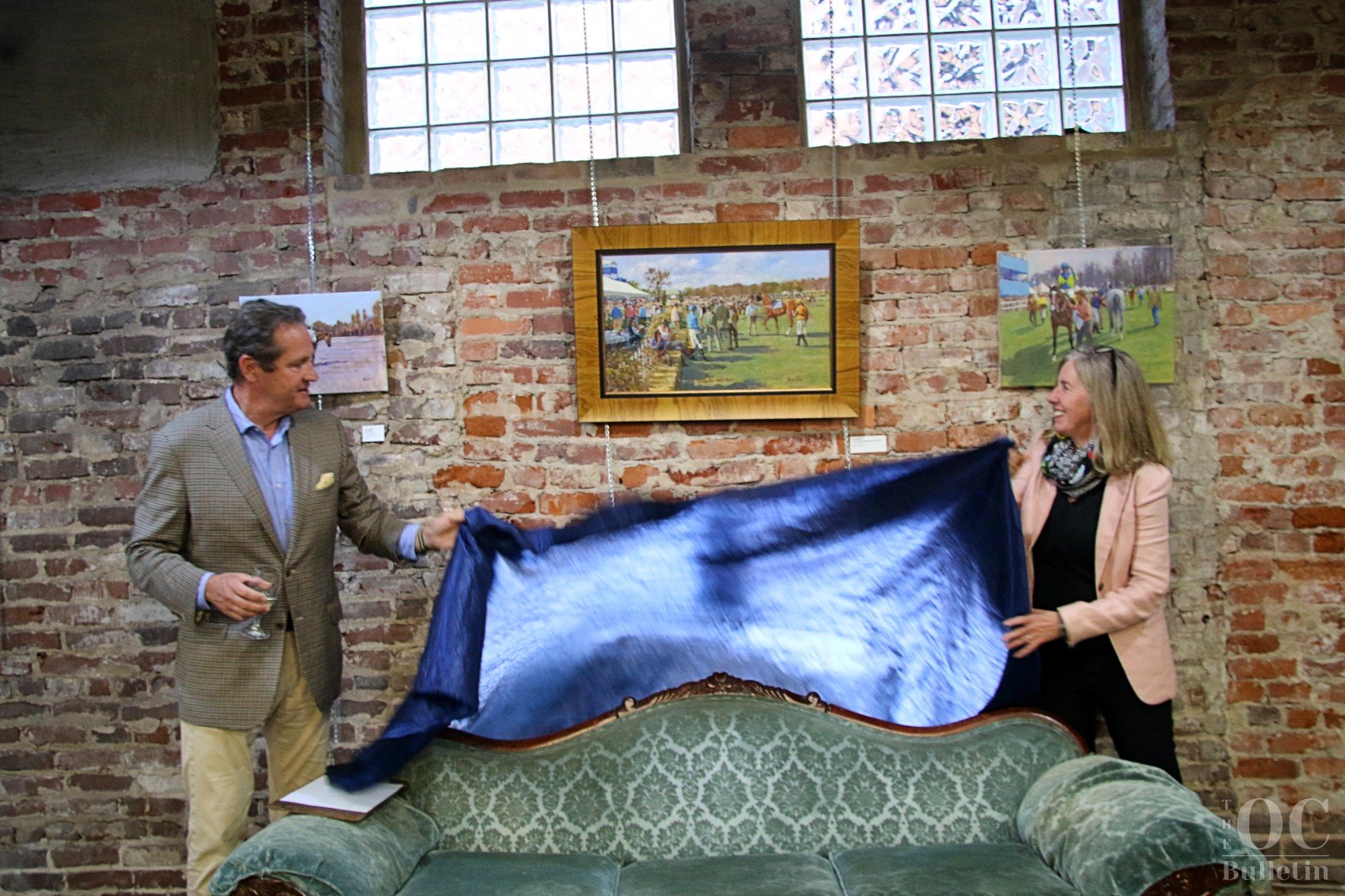  Montpelier Steeplechase Foundation Chair David Perdue and Kelly Coffin unveil the 2023 hunt races painting “The Paddock, Montpelier at Its Finest” by Jim Power. (Photo Credit: Andra Landi) 
