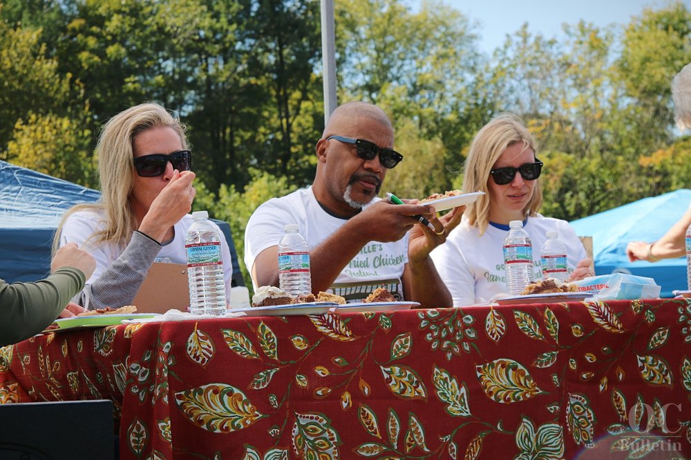  Chicken festival judge Charles Thomas carefully contemplates a slice of pie during the bake-off contest. (Photo Credit: Andra Landi) 