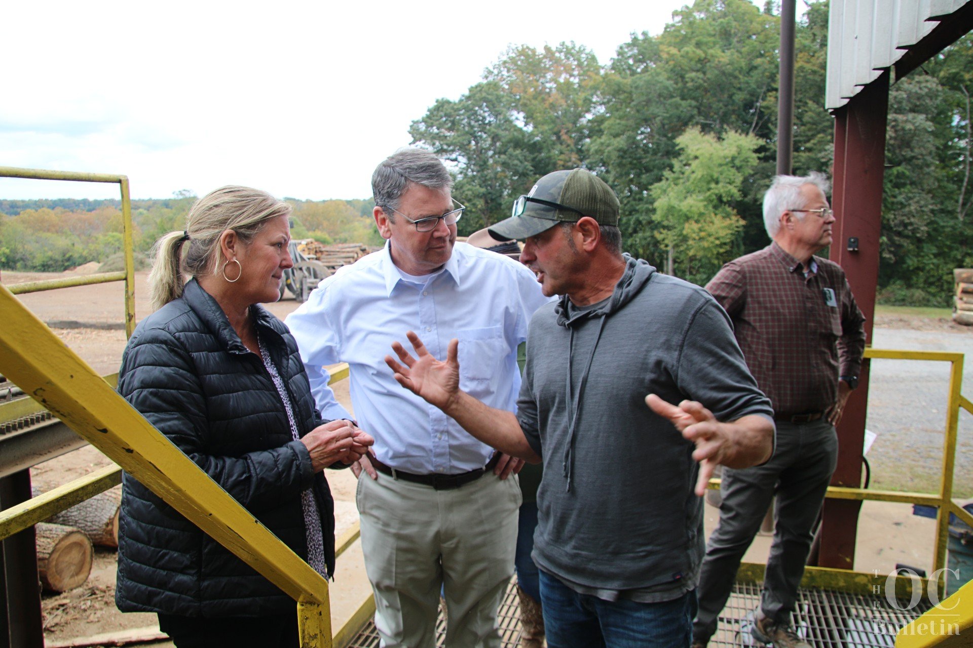  Jamie Coleman describes the process of trimming yellow poplar to Lesley Moseley, Sec. Matthew Lohr and Ed Zimmer. (Photo Credit: Andra Landi) 