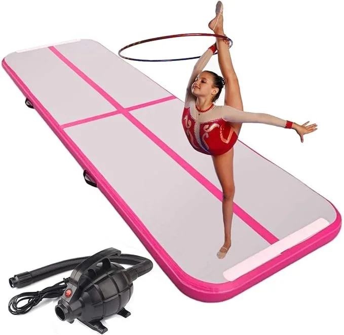 A young woman in a gymnastics outfit practicing rhythmic gymnastics on a trampoline with a hula hoop, with an air pump nearby.