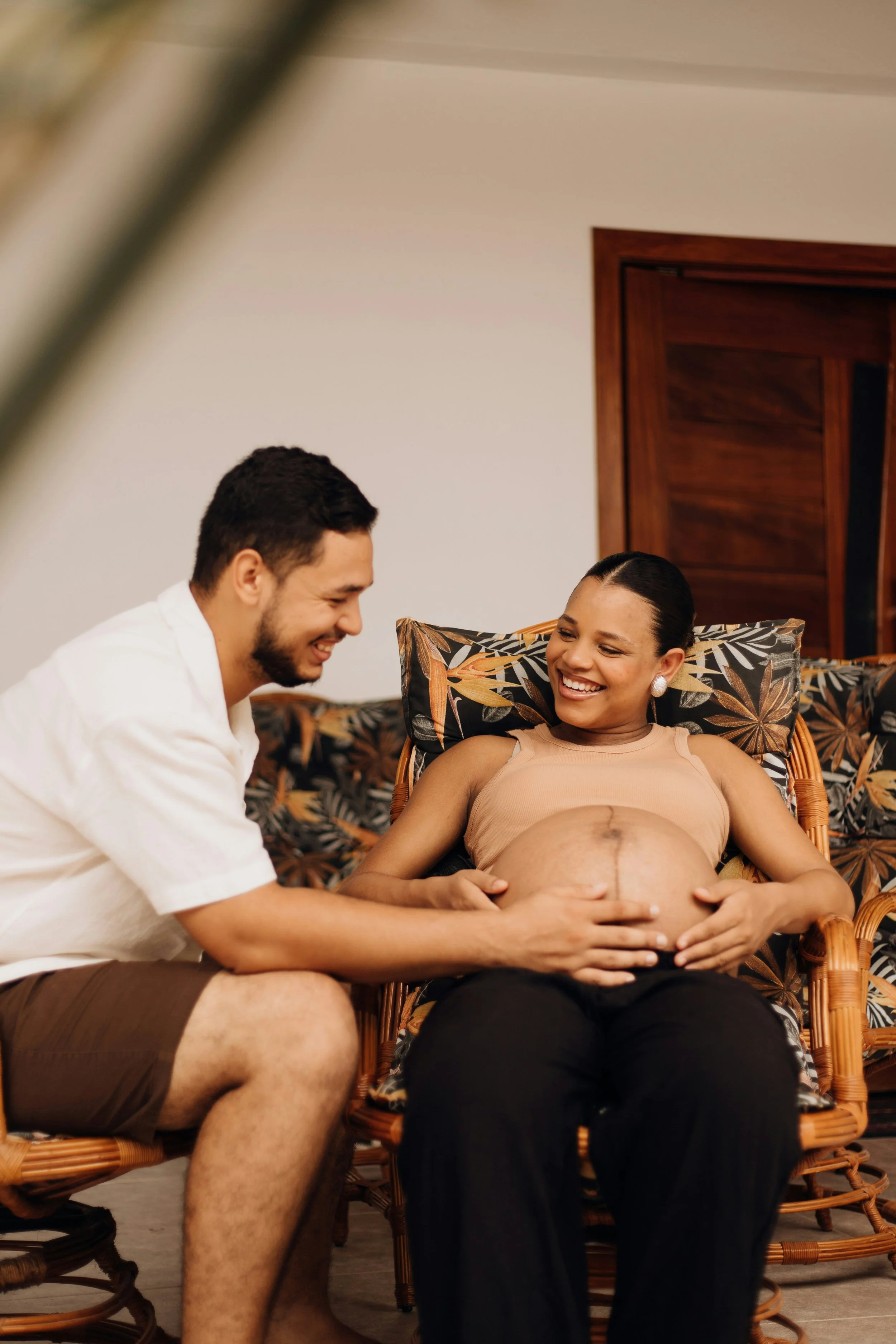 Pregnant woman and husband smiling about perinatal counselling and parenting support in Burnaby BC