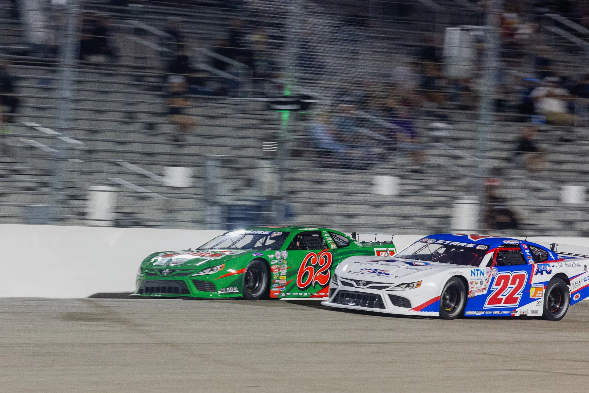 Asphalt late model cars racing on track  at Owosso Speedway