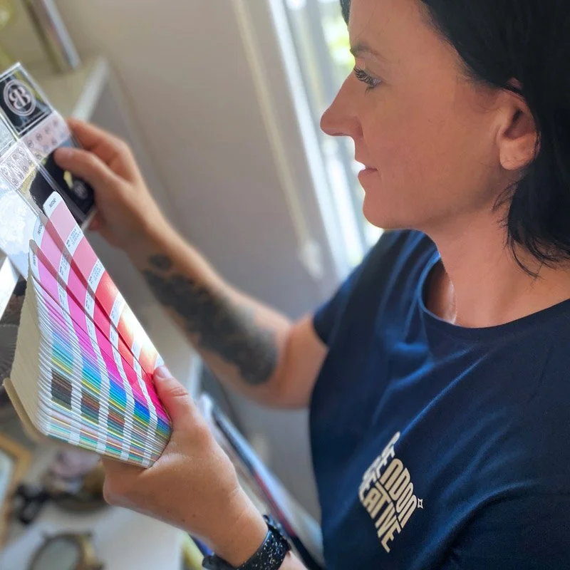 Designer reviewing colour samples as part of a branding and creative consulting process