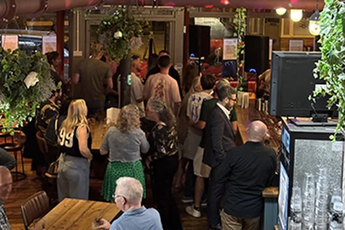 People waiting in line at the busy bar