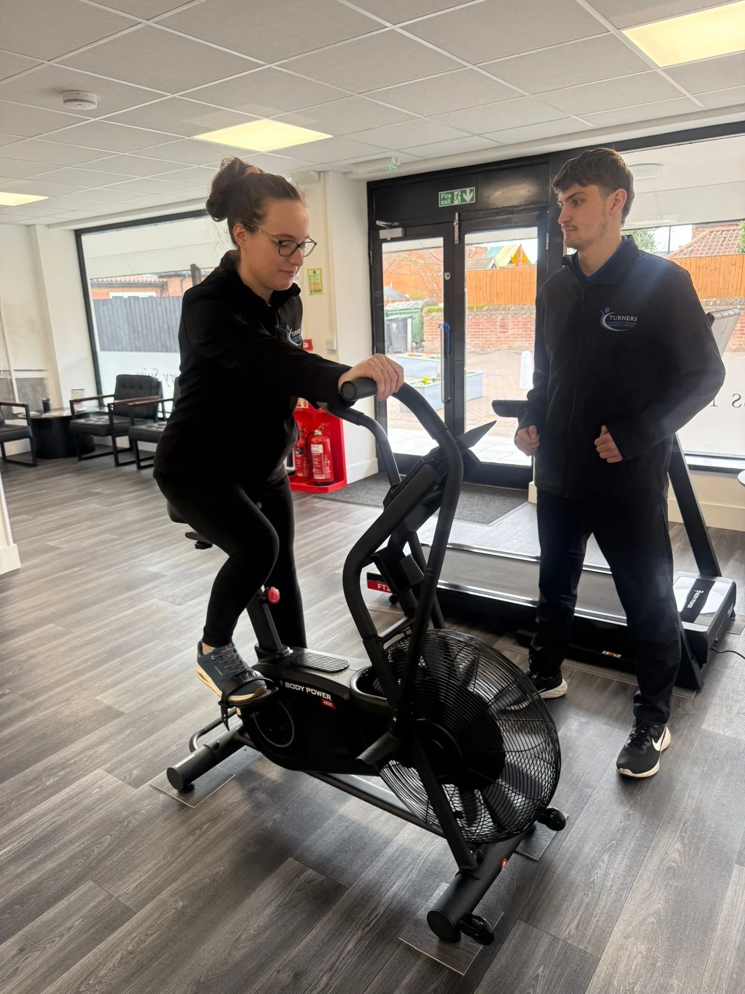 Person on exercise bike in the recovery suite