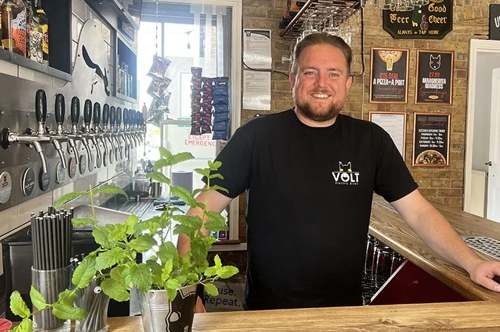 James standing behind the bar 