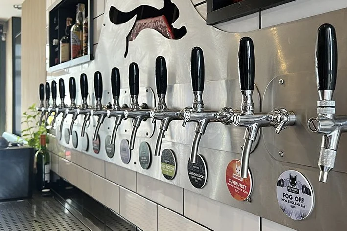 Series of tapped kegs or tap handles in the bar