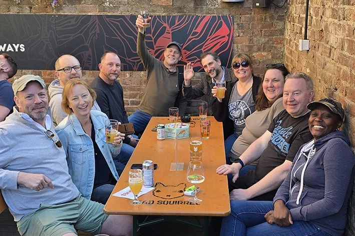 Group of people enjoying drinks together in the garden