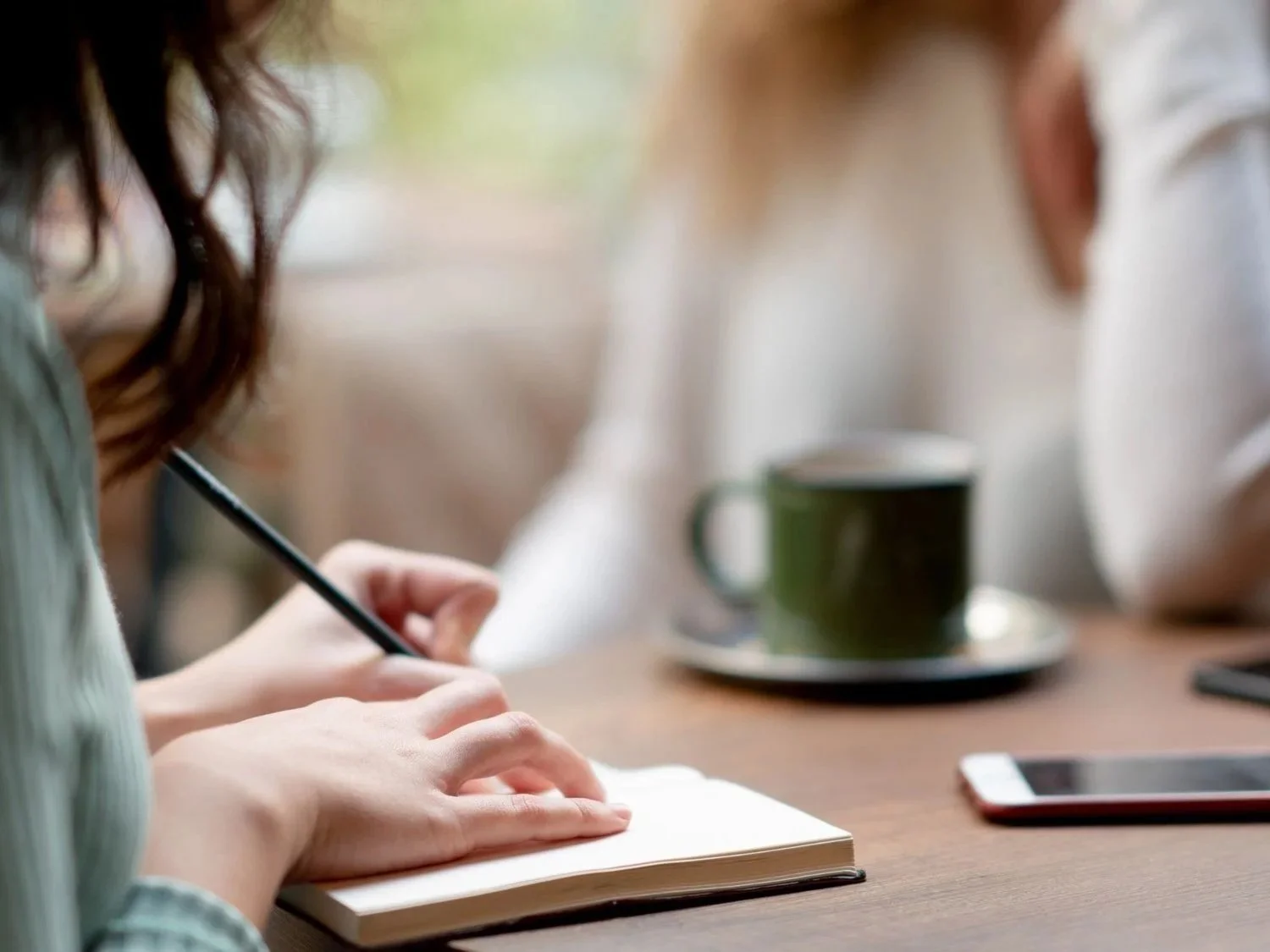 woman sitting at a table journaling