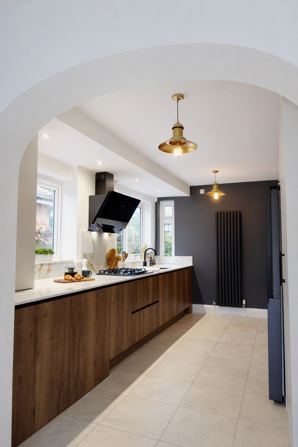 A bright, contemporary kitchen designed with clean lines and warm natural materials. Entered through a soft arched opening, the space features sleek walnut cabinetry paired with a light quartz worktop, creating a striking contrast with the dark accen