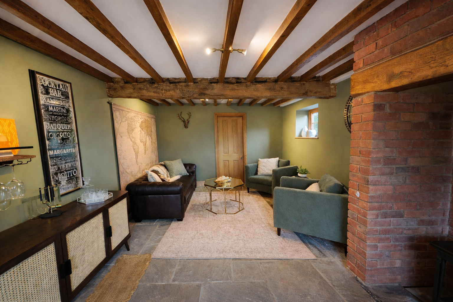 A richly layered living space that balances rustic architecture with refined, contemporary styling. Exposed timber ceiling beams and a substantial original beam span the room, complemented by warm brick detailing that adds depth and a sense of herita