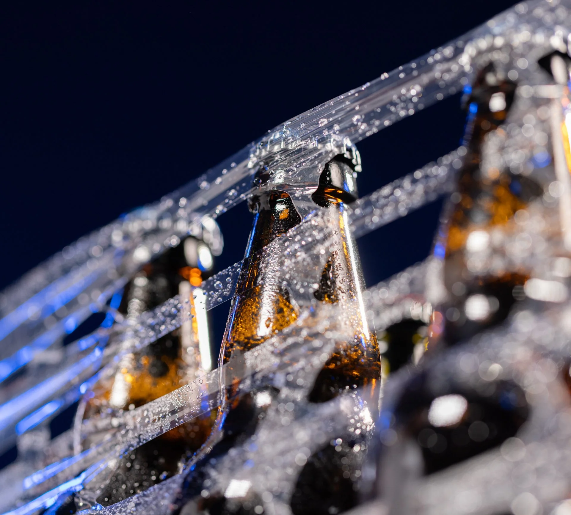 Mixed beverage bottles wrapped in ExcelAir ventilated pallet wrap reducing condensation and stabilising pallets