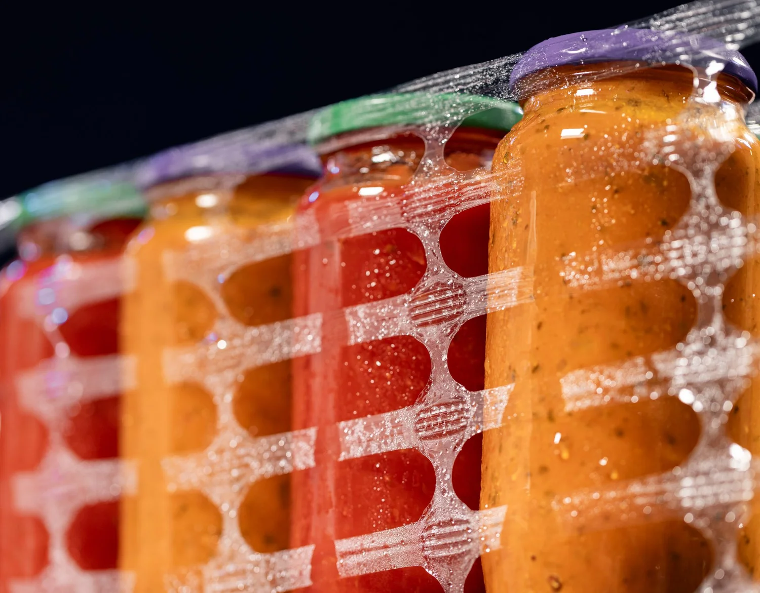 Glass sauce bottles wrapped in ExcelAir perforated pallet wrap preventing condensation and label damage