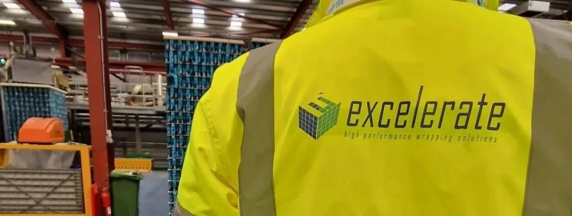 Pallet wrapper repair engineer inspecting machinery in UK warehouse