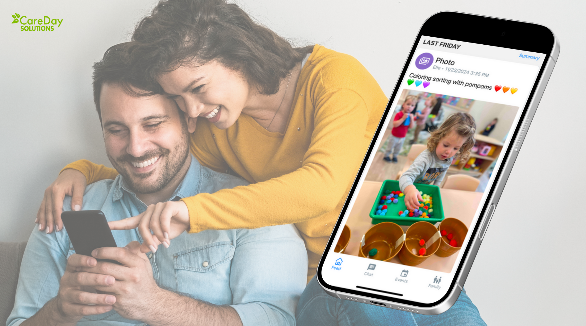 Parents viewing a classroom update on their phone from the CareDay app, featuring a child sorting colorful pompoms during a preschool activity.