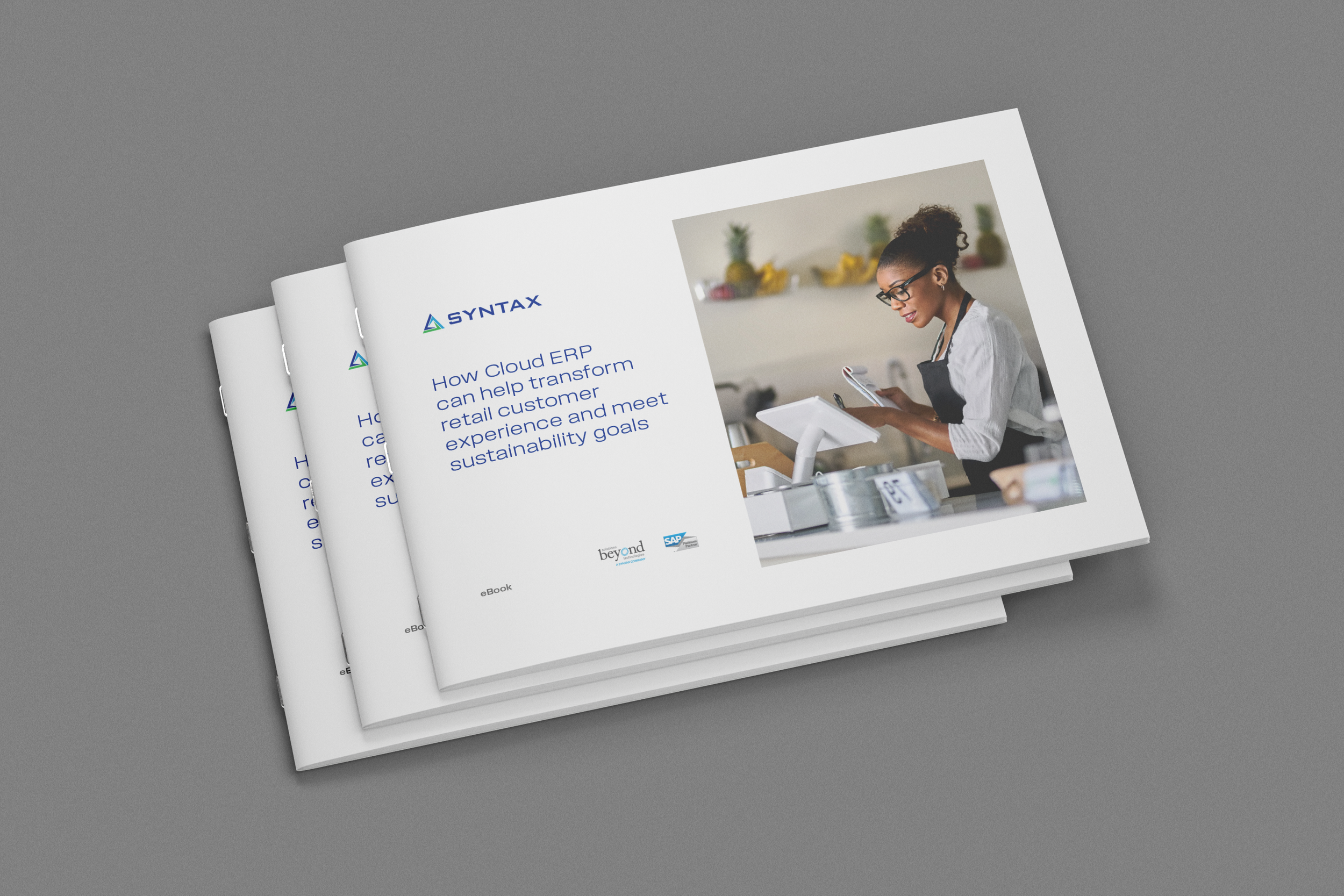 Open booklet with a cover title about how cloud ERP can help transform retail customer experience and meet sustainability goals, featuring a woman using a smartphone in a modern kitchen.