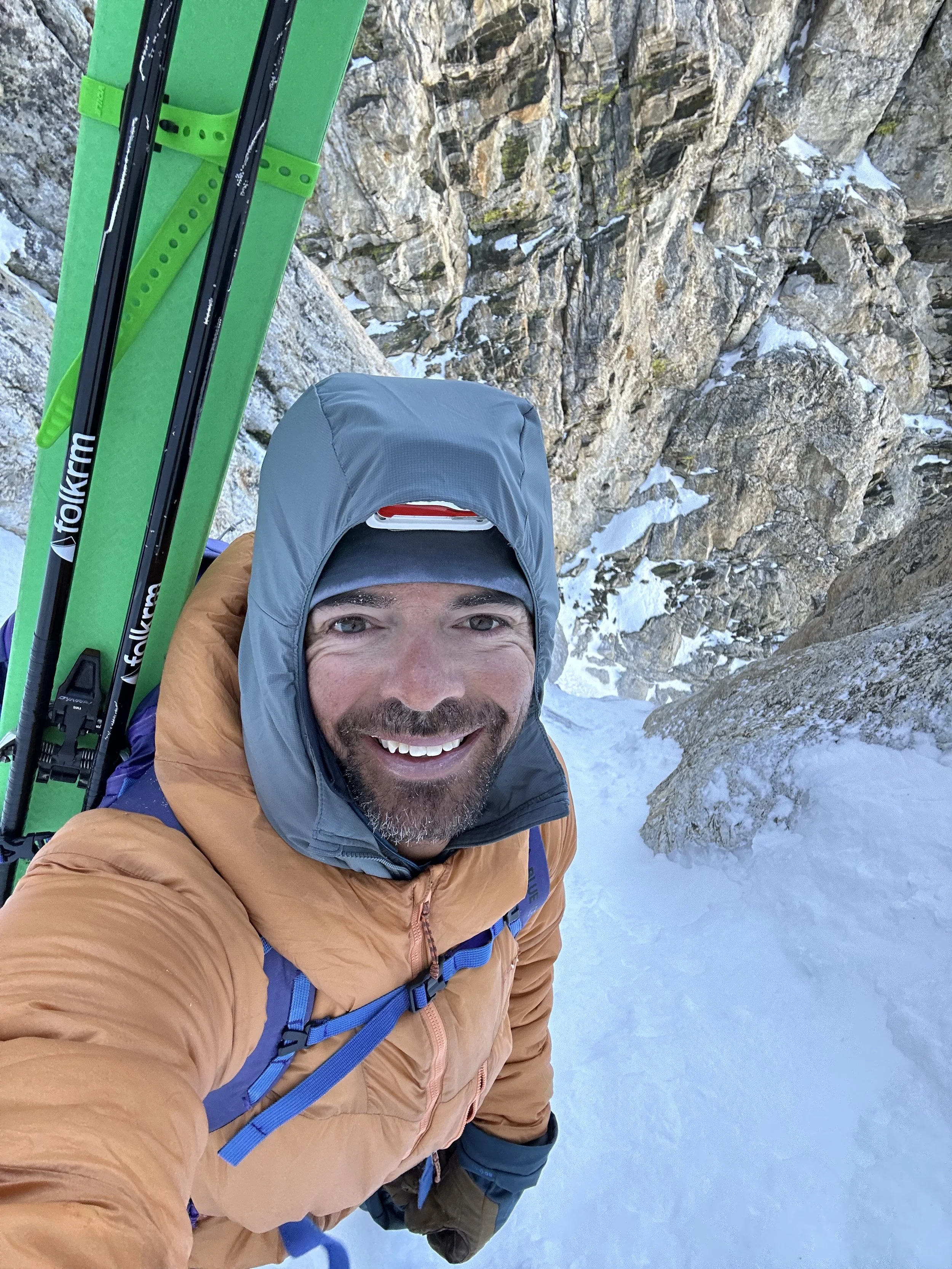 Man taking a selfie on a snowy mountain with rappel gear. Mountain Training Center.